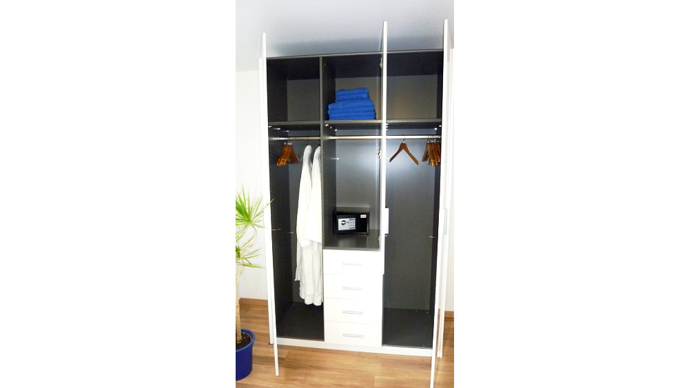 Wardrobe with coat hangers and safe